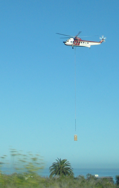 Helicopter lifting outhouse