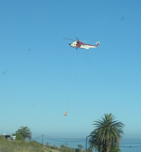 Helicopter lifting outhouse