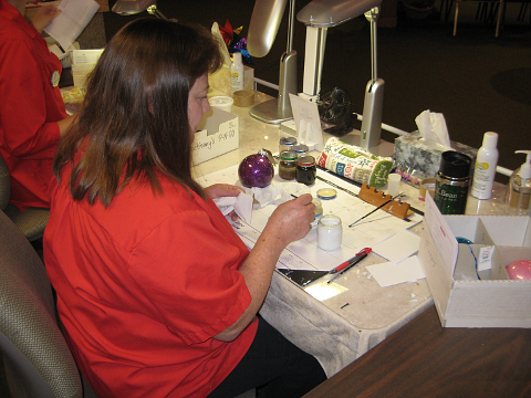 Worker painting ornaments