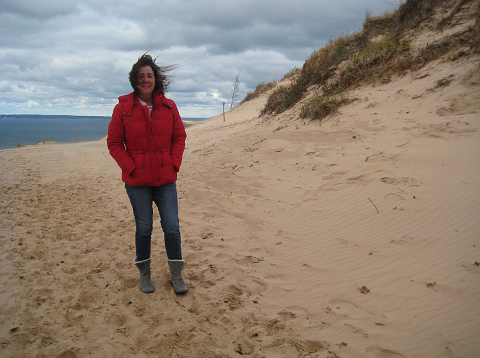 Woman standing on the dunes in the wind