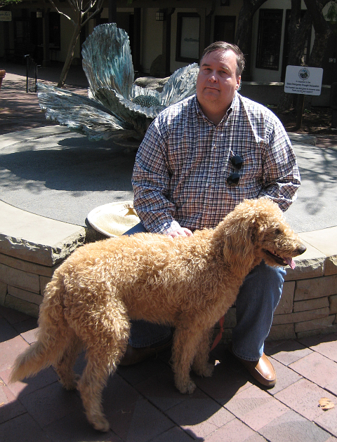 Sitting next to fountain with dog