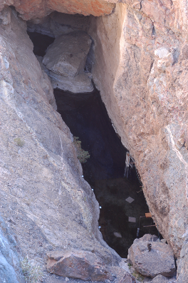 Dark water at the bottom of a rock chasm
