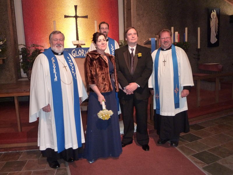 Bride and groom standing at alter