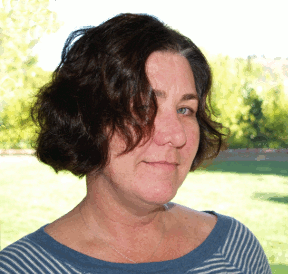 Portrait of a woman, against a background of green plants