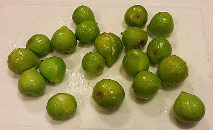 Green figs on a white cutting board