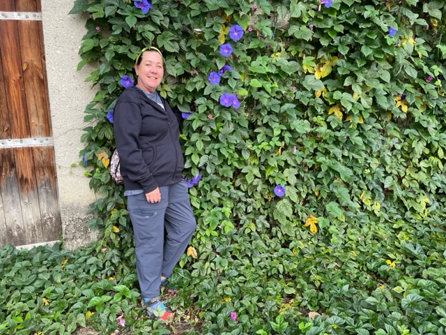 Woman in front of flowers