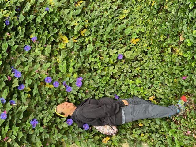 Woman in front of flowers
