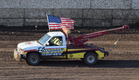 Tow truck parading flag